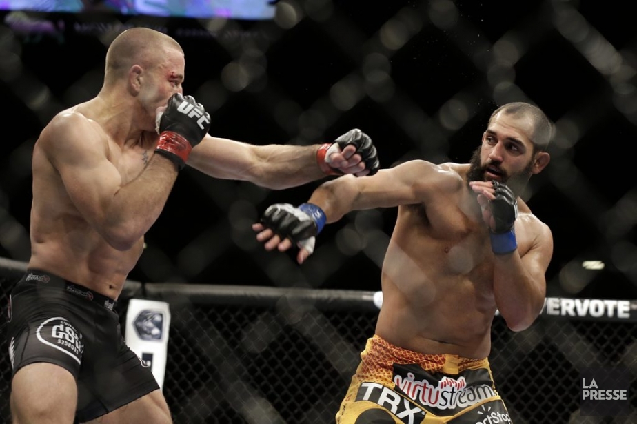 Georges St-Pierre face à Johny Hendricks.... (Photo Isaac Brekken, AP)